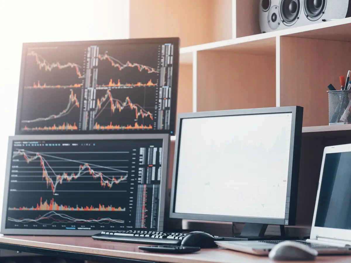 Trading screens with market charts on a desk