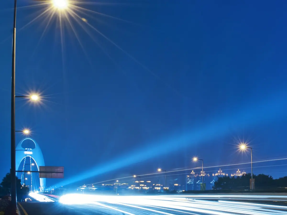 Light streaks along a city road at night
