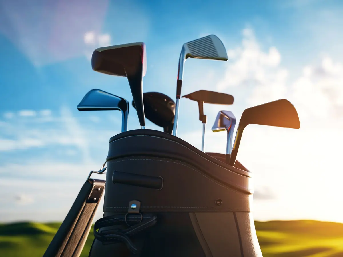A golf bag on a fairway at sunrise